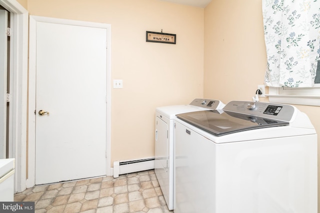 clothes washing area featuring washing machine and clothes dryer and a baseboard heating unit