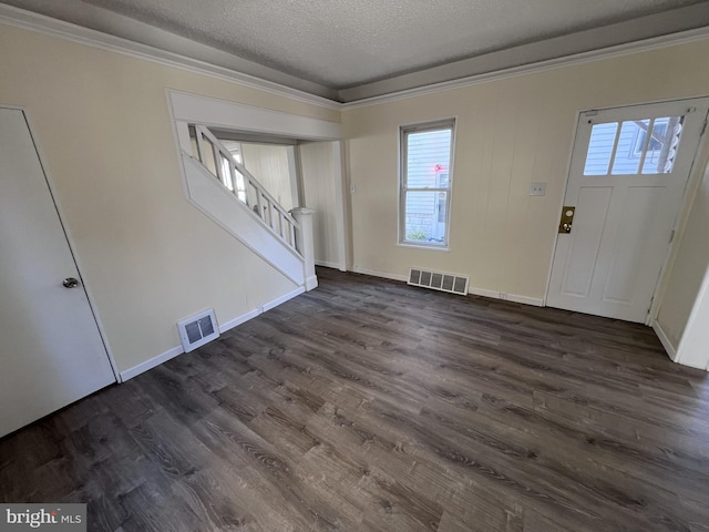 entryway featuring dark hardwood / wood-style flooring, a textured ceiling, and crown molding