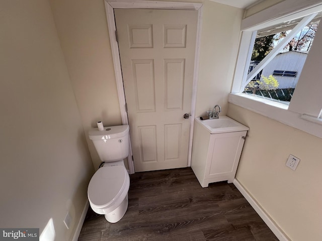 bathroom featuring hardwood / wood-style floors, vanity, and toilet