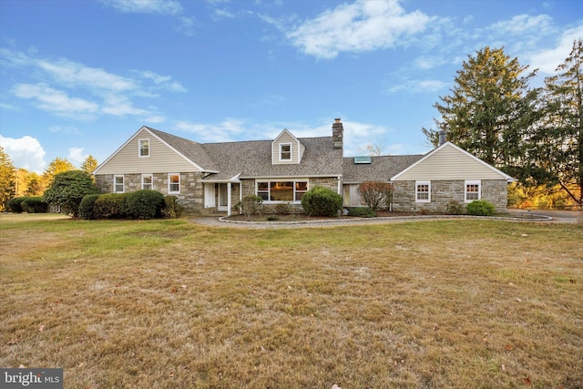 cape cod home with a front yard