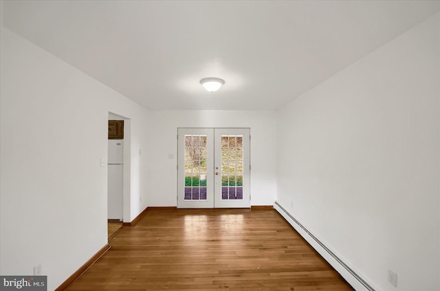 entryway featuring a baseboard heating unit, french doors, and wood-type flooring