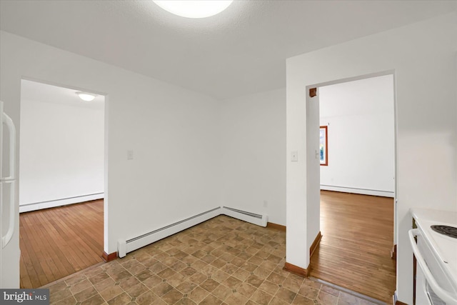 unfurnished room with hardwood / wood-style flooring and a baseboard heating unit