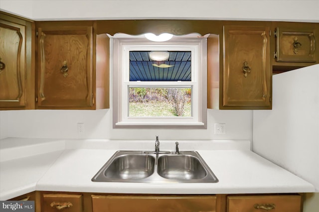 3315 E College Ave, Bellefonte, PA 16823 - kitchen with a sink, light countertops, and brown cabinetry