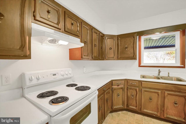 3315 E College Ave, Bellefonte, PA 16823 - kitchen featuring white electric range, a sink, under cabinet range hood, brown cabinets, and light countertops