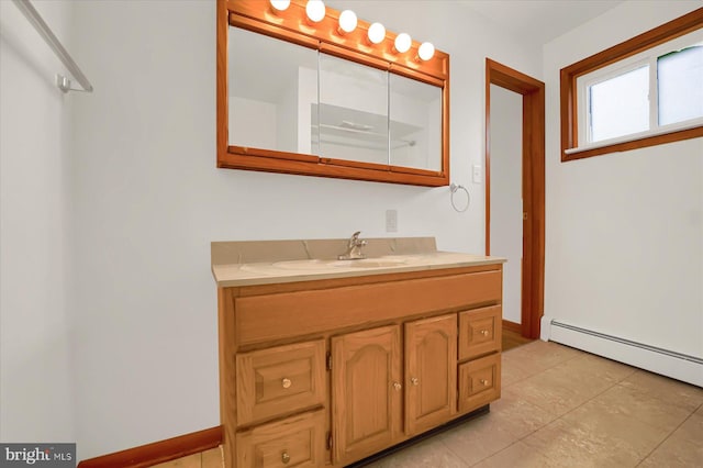 bathroom featuring tile patterned flooring, vanity, and a baseboard radiator