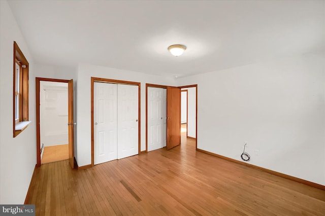 3315 E College Ave, Bellefonte, PA 16823 - unfurnished bedroom with light wood finished floors, multiple closets, and baseboards