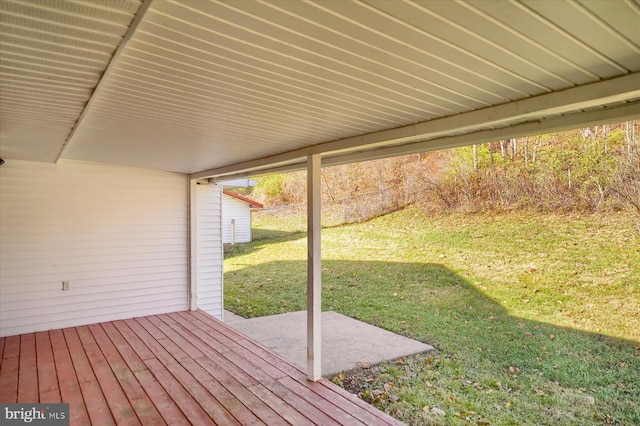 wooden deck with a patio and a yard