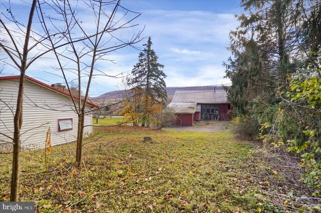 3315 E College Ave, Bellefonte, PA 16823 - view of green lawn featuring a barn, an outbuilding, and a mountain view