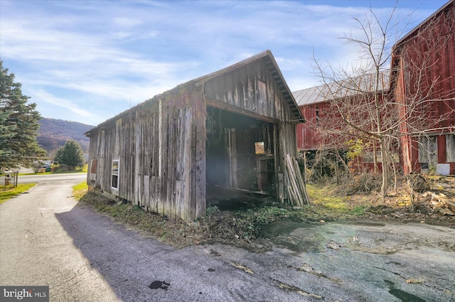 view of side of home with a mountain view