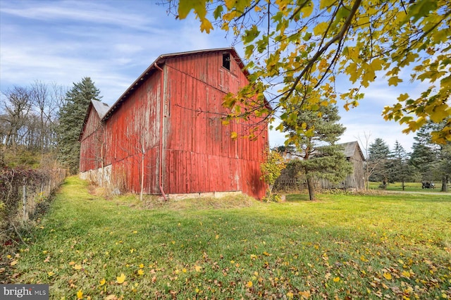 view of outbuilding featuring a lawn