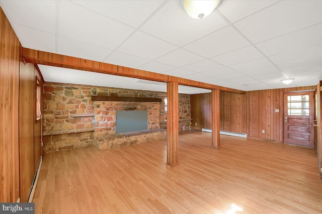 3315 E College Ave, Bellefonte, PA 16823 - basement with a baseboard heating unit, a paneled ceiling, wood finished floors, and wood walls