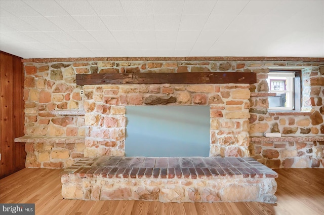 interior details with hardwood / wood-style floors and wooden walls