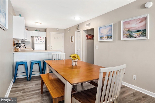 dining space featuring dark hardwood / wood-style floors