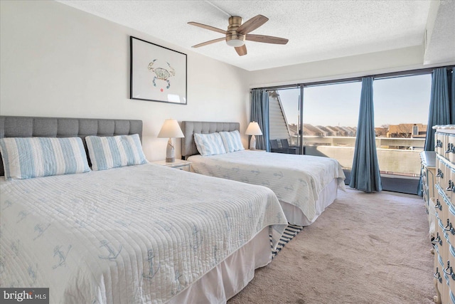 bedroom featuring light carpet, a textured ceiling, and ceiling fan