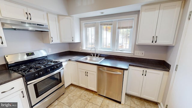 kitchen with white cabinets, light tile patterned floors, sink, and appliances with stainless steel finishes