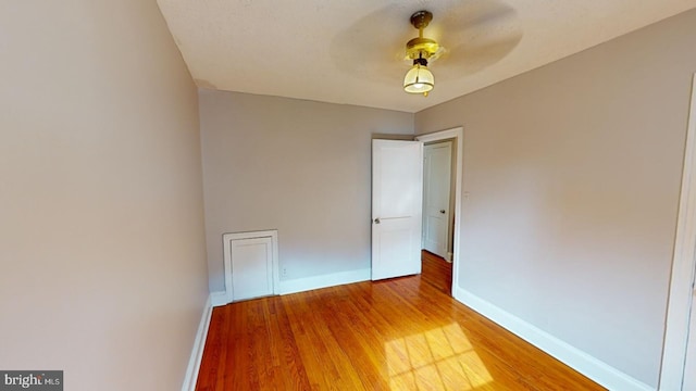 unfurnished room with hardwood / wood-style floors and ceiling fan