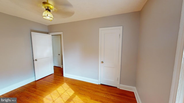 unfurnished bedroom featuring ceiling fan and wood-type flooring