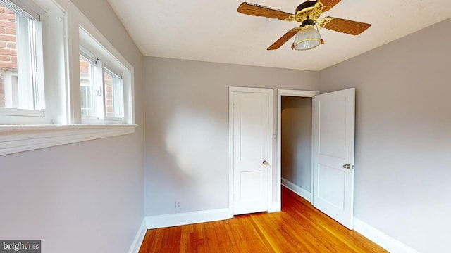 unfurnished bedroom featuring hardwood / wood-style flooring and ceiling fan