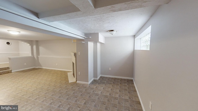 basement featuring a textured ceiling