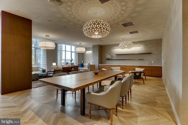 dining space featuring light parquet flooring