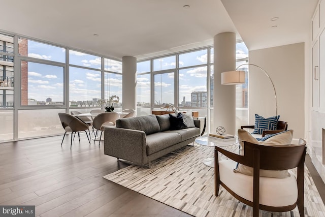 living room with plenty of natural light, hardwood / wood-style flooring, and floor to ceiling windows