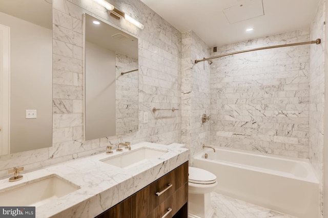 full bathroom featuring tiled shower / bath, toilet, and vanity