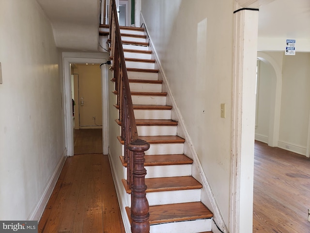 stairs with hardwood / wood-style floors