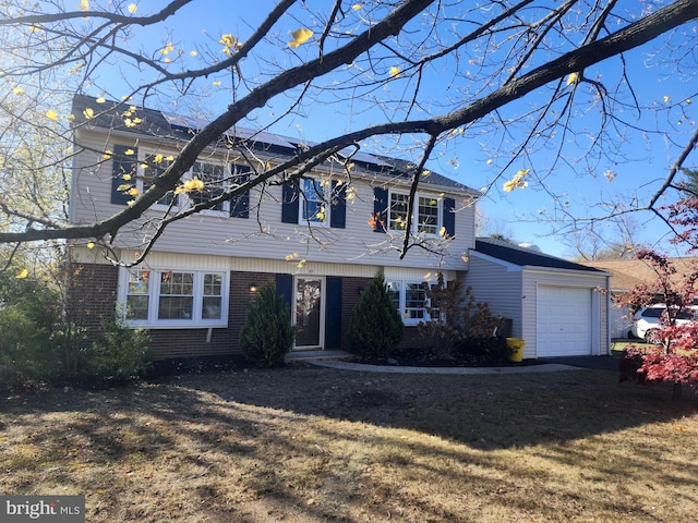 view of front of home with a front yard and a garage