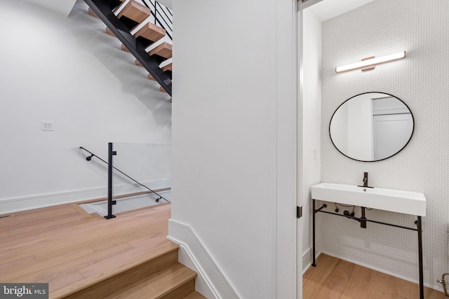 stairs with hardwood / wood-style floors