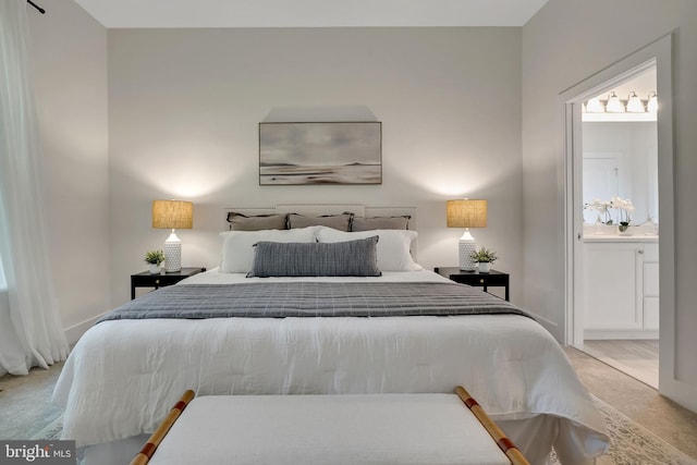 carpeted bedroom featuring ensuite bathroom