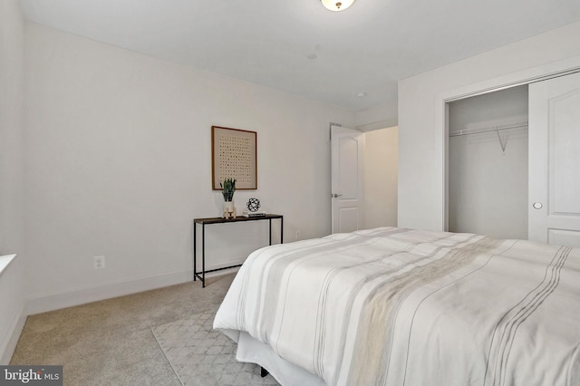 bedroom featuring a closet and light colored carpet