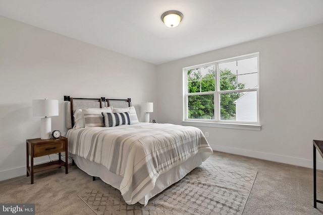 bedroom featuring light carpet