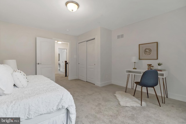 bedroom with light carpet and a closet