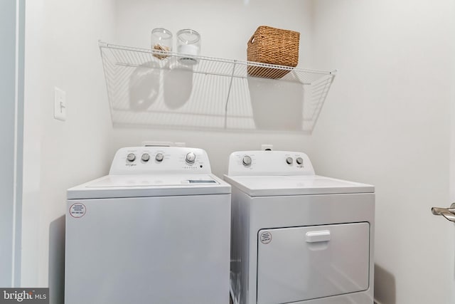 laundry room with washing machine and dryer