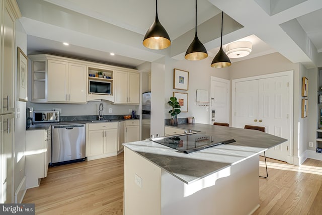 kitchen featuring kitchen peninsula, appliances with stainless steel finishes, pendant lighting, light hardwood / wood-style flooring, and a breakfast bar