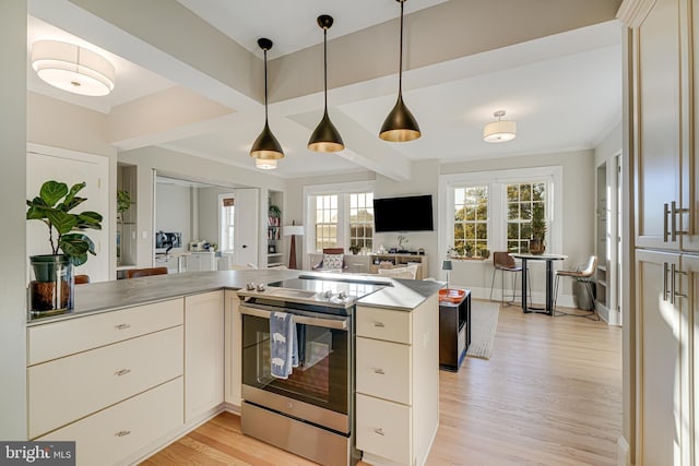 kitchen with light wood-type flooring, kitchen peninsula, pendant lighting, and stainless steel range with electric stovetop