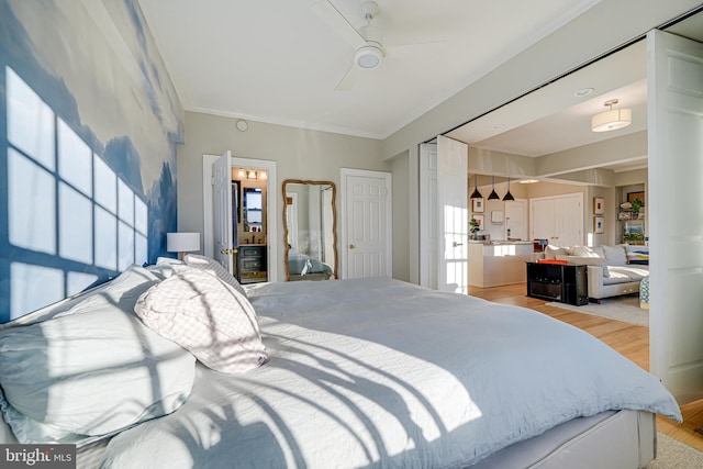 bedroom featuring ceiling fan, light wood-type flooring, and crown molding