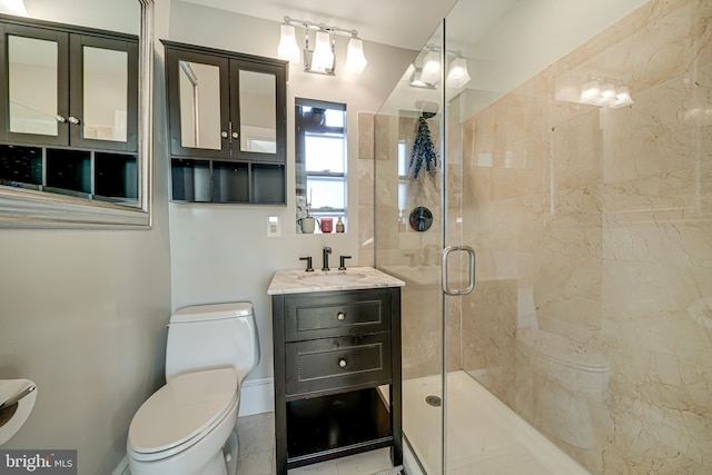 bathroom featuring a shower with shower door, toilet, and vanity