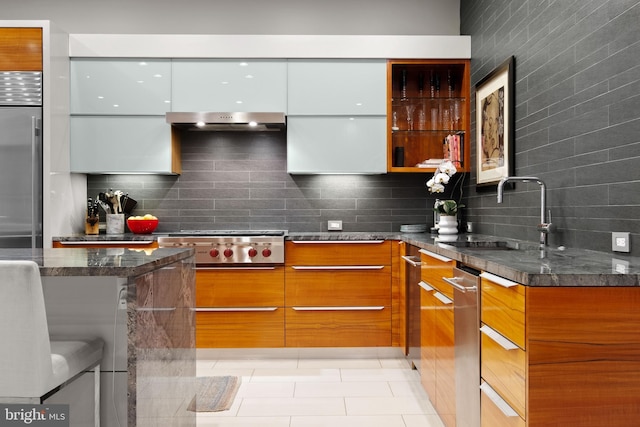 kitchen with white cabinetry, sink, backsplash, dark stone countertops, and appliances with stainless steel finishes