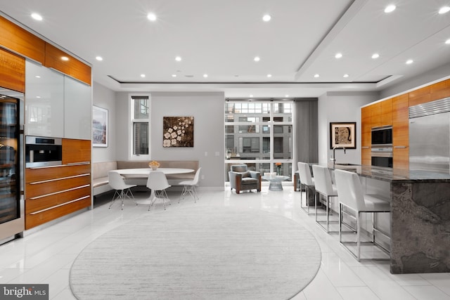 dining area with a raised ceiling