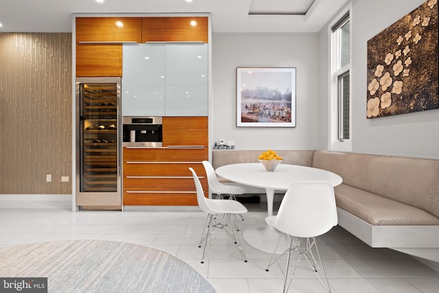 dining space with breakfast area, light tile patterned floors, and beverage cooler