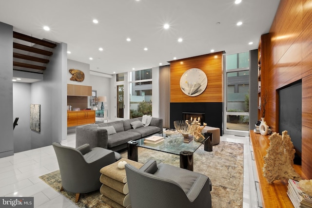 living room featuring light tile patterned floors and a large fireplace