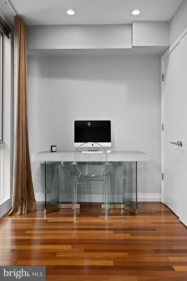 unfurnished office featuring hardwood / wood-style floors