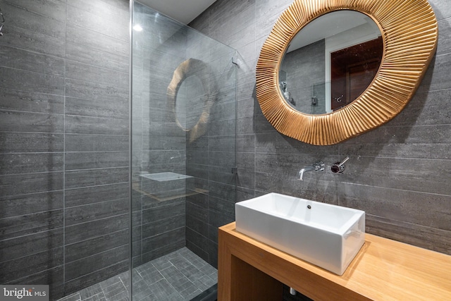 bathroom with vanity and tiled shower