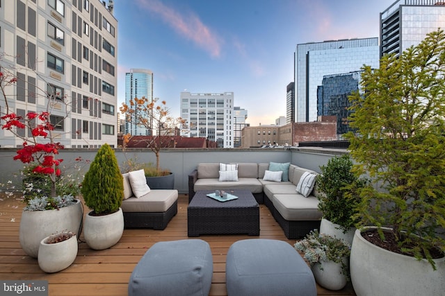 deck at dusk featuring an outdoor living space