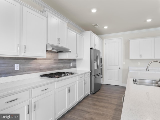 kitchen with white cabinets, sink, appliances with stainless steel finishes, and dark wood-type flooring