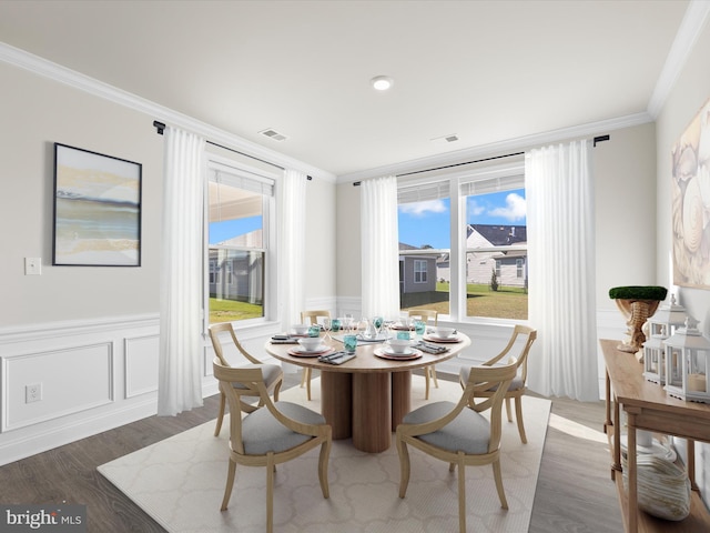 dining area with dark hardwood / wood-style floors and crown molding