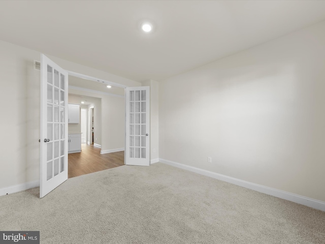 carpeted spare room with french doors