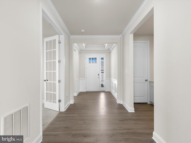 entryway with dark wood-type flooring and crown molding