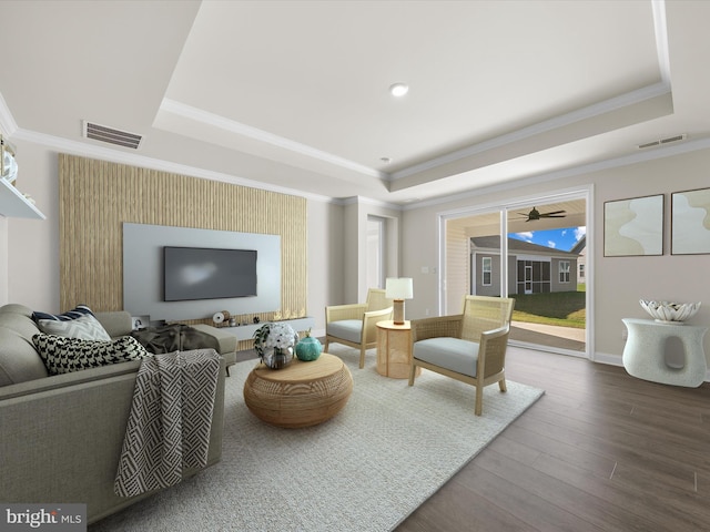 living room featuring a raised ceiling, hardwood / wood-style floors, and ornamental molding